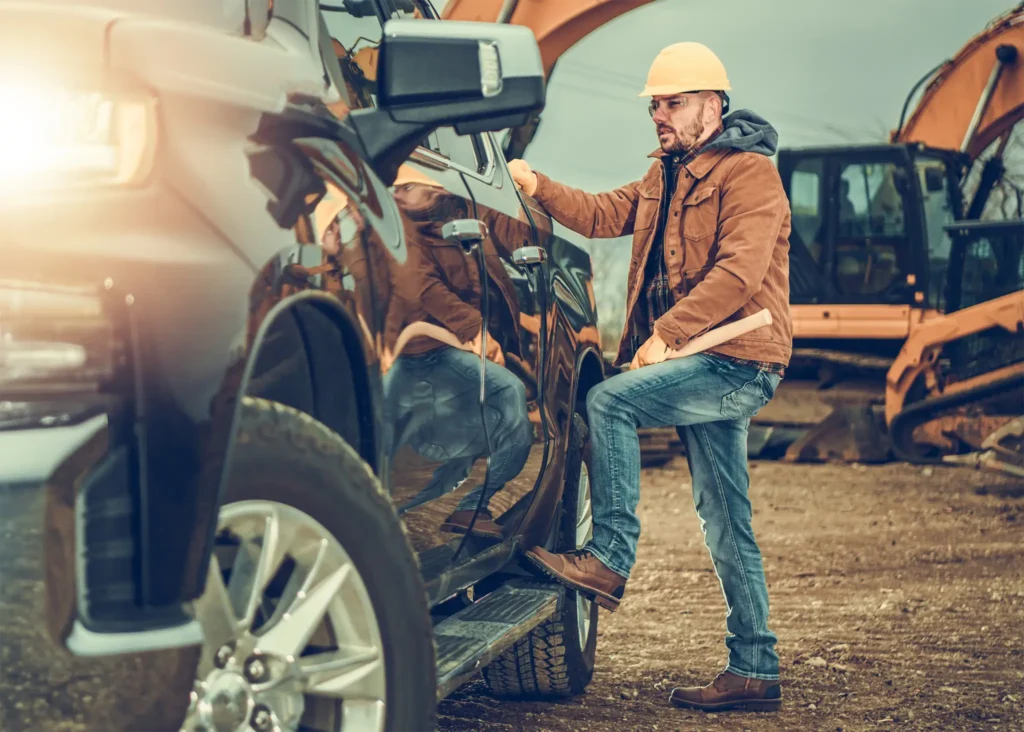 Construction Contractor in Yellow Hardhat near pickup truck - Colorado West Insurance is here to protect your Construction or Contracting business with the perfect insurance plan.